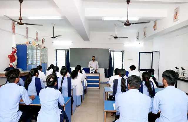 Students in lab coats seated in the zoology laboratory.